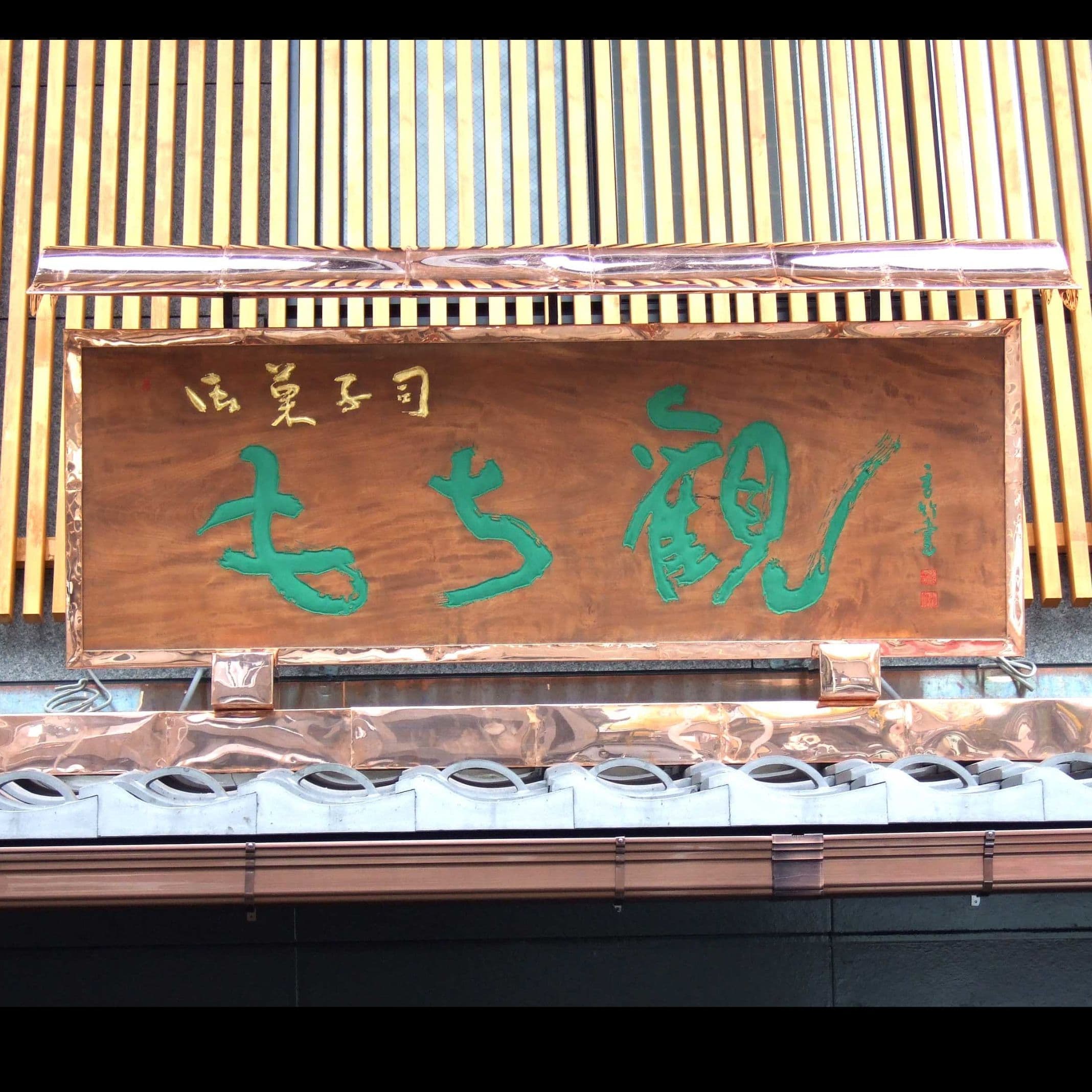 銅板がきれいな木の看板、文字は彫ってあり緑青と金箔